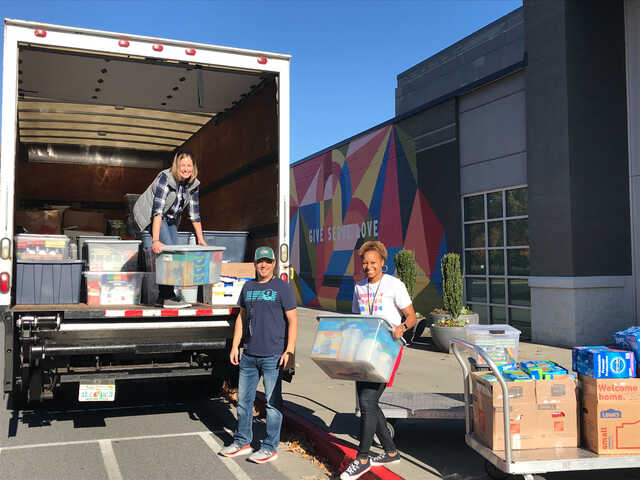 3 volunteers load a box truck with donations outside of north point community church